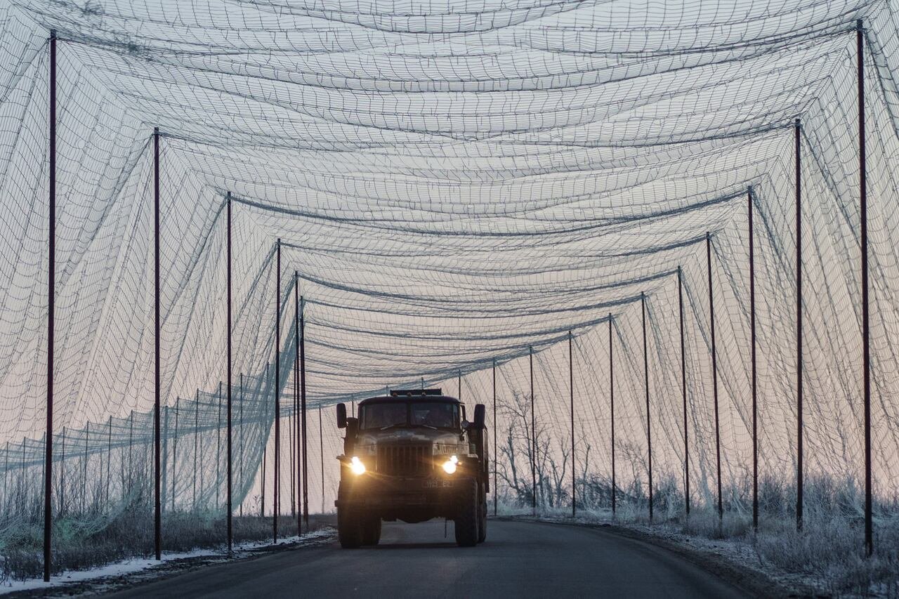 A military truck moves along a road covered with an anti-drone net, amid Russia's attack on Ukraine, in Kharkiv region, Ukraine, on Jan. 21.