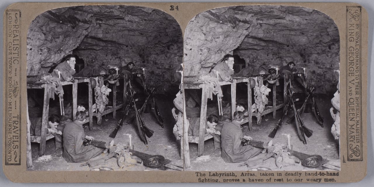 default-666 Dual black and white images of first world war soldiers at rest in a cave with wooden bunks constructed