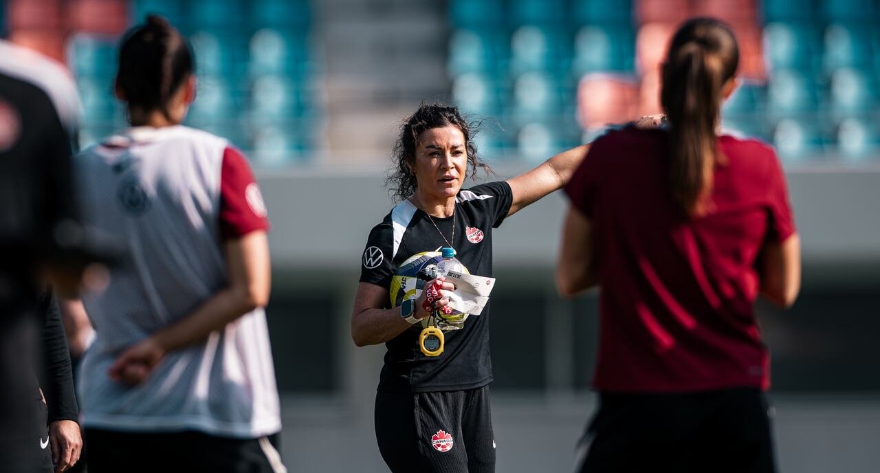An assistant coach representing Canada giving instructions.